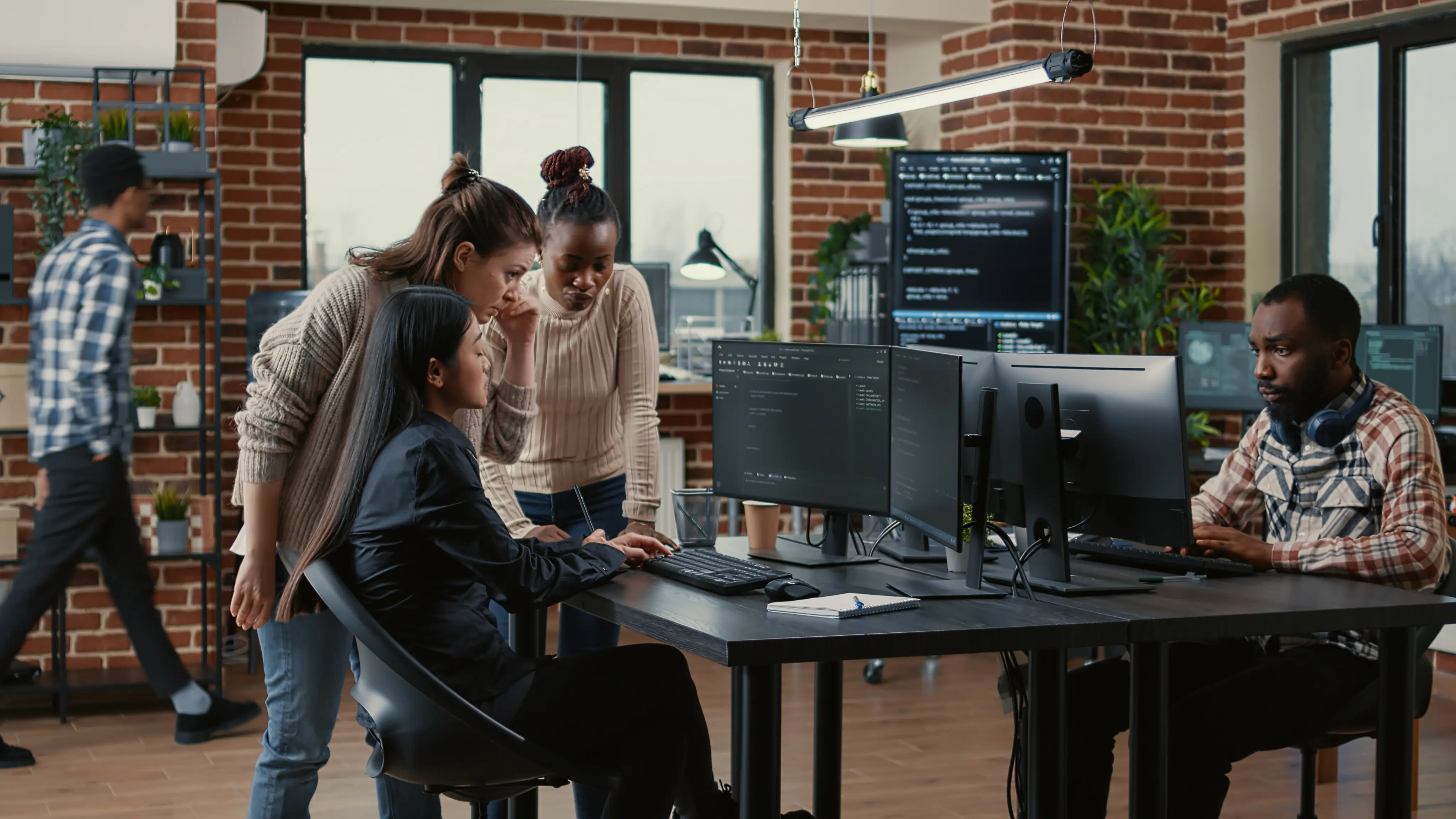 People working with a monitor